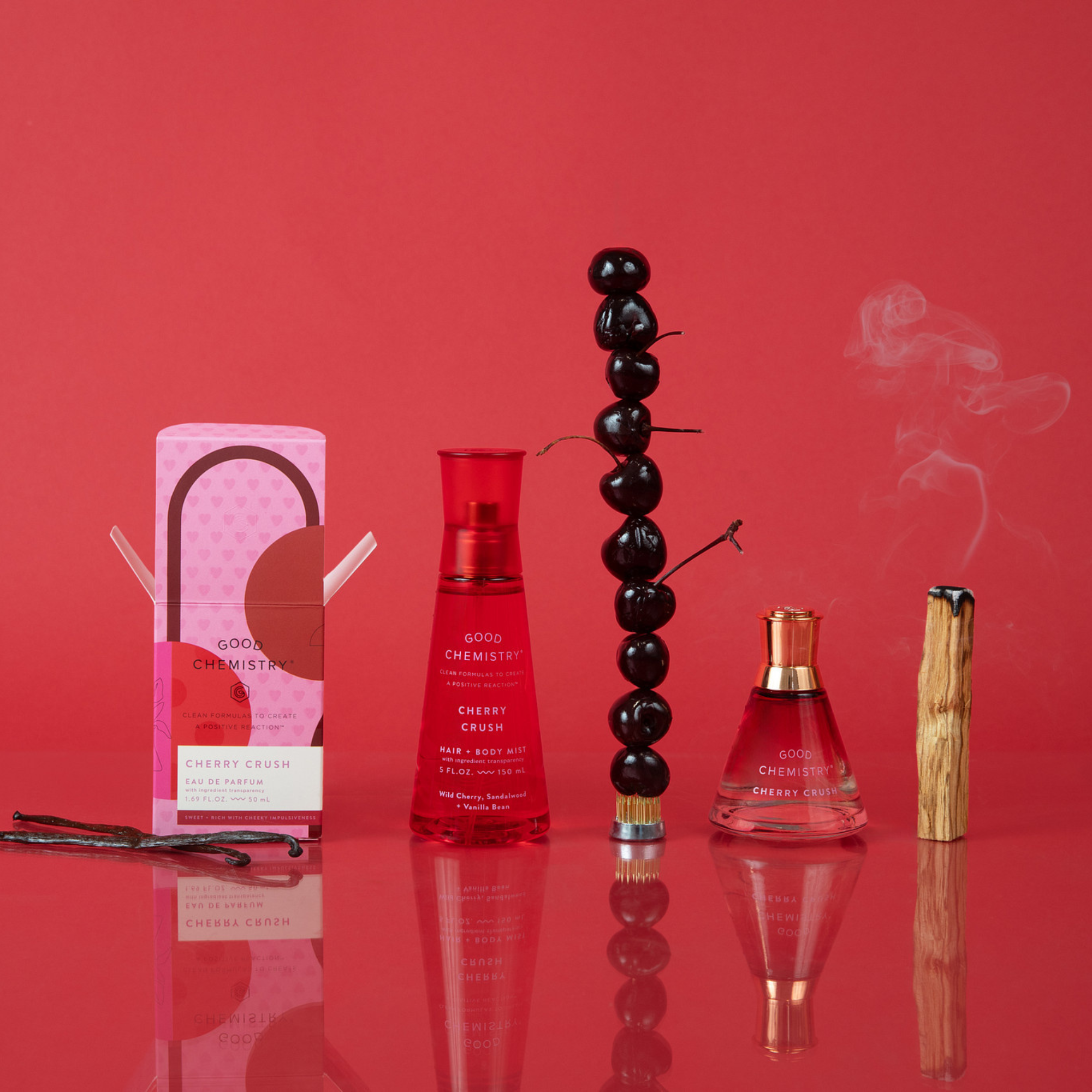 Cherry Crush Perfume bottles and packaging on a red background