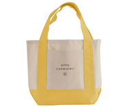 Yellow and beige tote bag with 'Good Chemistry' logo on a white background