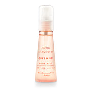 A pink spray bottle labeled 'GOOD CHEMISTRY Queen Bee Body Mist' with text indicating fragrance notes of black currant, peony, and amber.