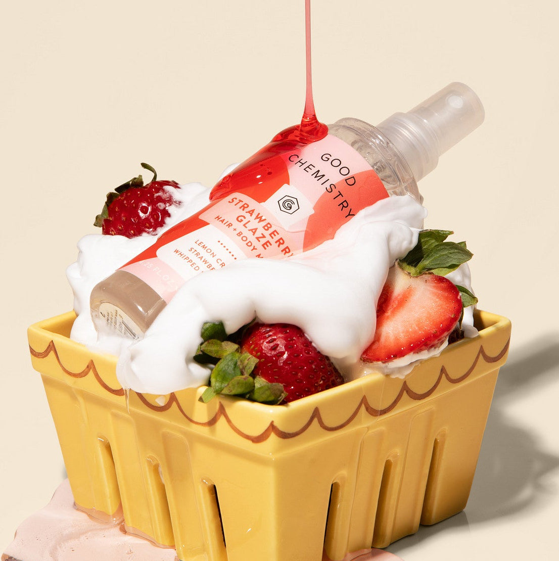 Good Chemistry Strawberry Glaze spray in a yellow basket on a beige background