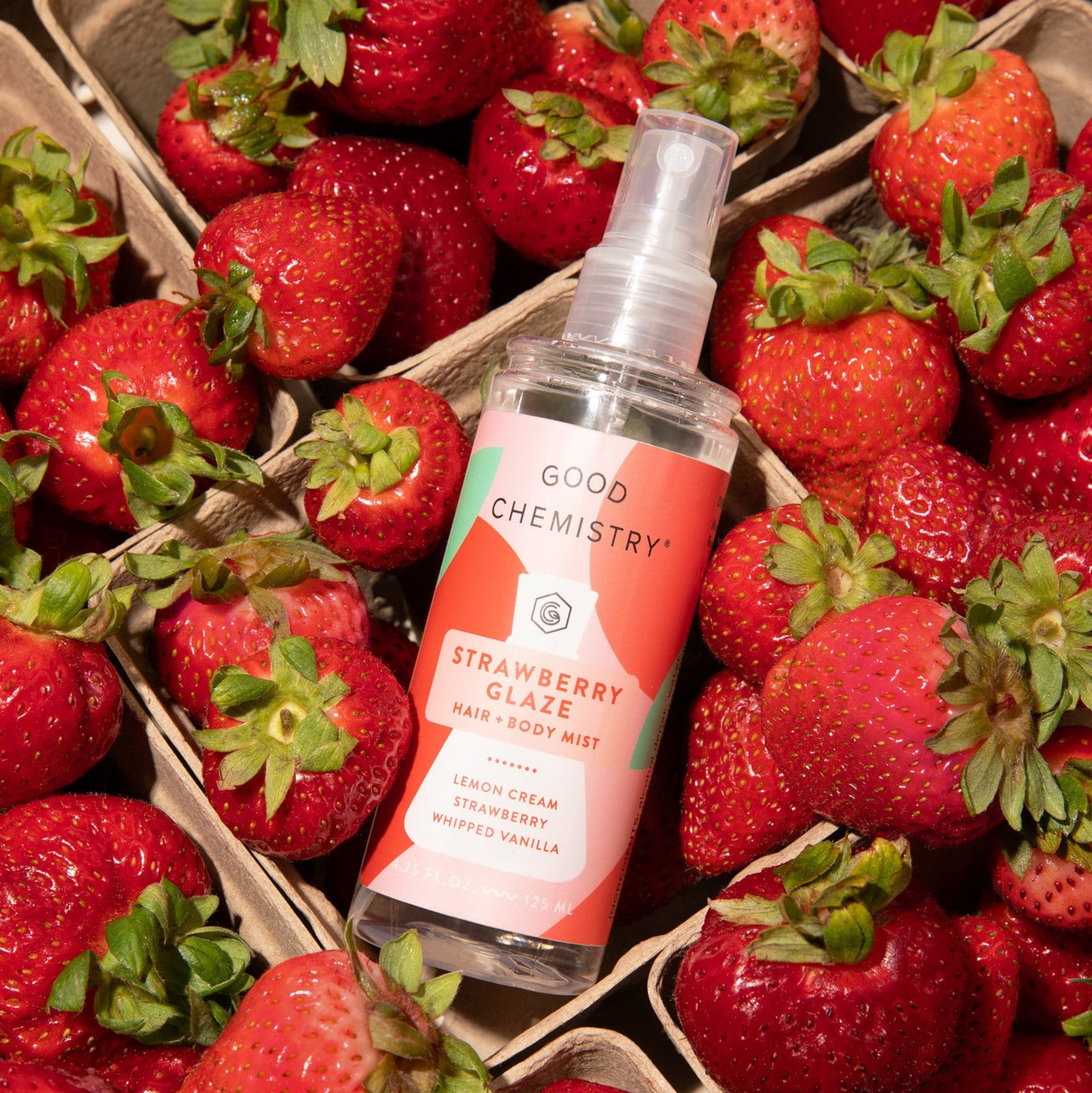 Spray bottle labeled 'Good Chemistry' surrounded by strawberries