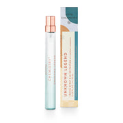 A travel spray bottle with a clear liquid and a rose gold cap, next to its packaging box which has 'Unknown Legend' written on it.