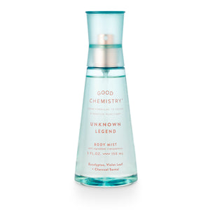 A clear spray bottle labeled 'GOOD CHEMISTRY UNKNOWN LEGEND BODY MIST' with a blue cap and translucent blue liquid visible inside.